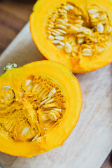 Half a ripe orange pumpkin on a cutting board. Ingredients for cooking.