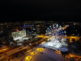 Aerial view of the pond and the Ferris wheel. Night and winter. Kirov city (Russia).