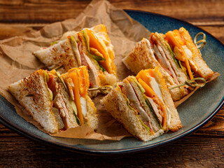 club sandwiches with lemonade on a wooden background