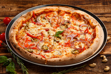 Pizza with holopeno, onion and cheese on wooden background