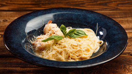 pasta with shrimps and cheese on wooden background