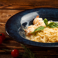 pasta with shrimps and cheese on wooden background