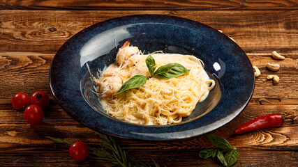 pasta with shrimps and cheese on wooden background