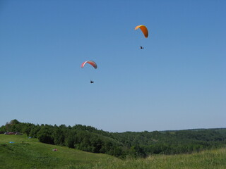 parachutes with a motor in the blue sky