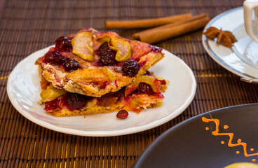 Homemade cookies with fruit in a white saucer on a bamboo mat