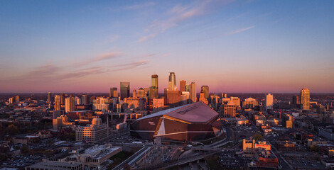 Drone flight over the skyline of Minneapolis, Minnesota USA with a nice view to the US Banks Stadium from the Vikings  - obrazy, fototapety, plakaty