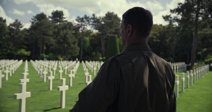 Close up, soldier looks at Normandy American Cemetery