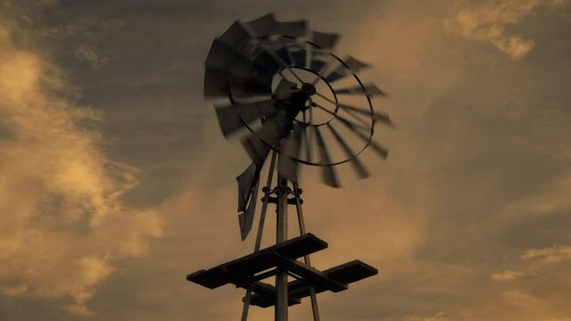 Colorful sunset over windmill, low angle