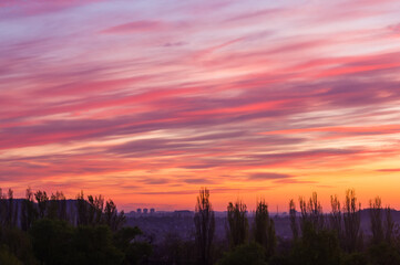 Landscape with dramatic light - beautiful golden sunset with saturated sky and clouds.