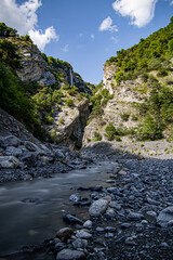 River flowing through valley on a sunny summer day. Switzerland nature