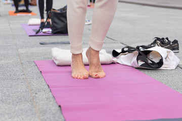 Crowd of yoga teachers protesting the Covid-19 blockade and restrictions. Female feet on the fitness mat.