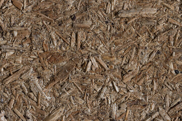 Chipboard texture. Rough particle board surface. Particleboard background. Wood building material. Close-up.