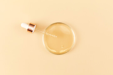Serum with pipette in petri dish on beige background. Top view, flat lay. Concept skincare. Dermatology science cosmetic laboratory. Natural medicine, cosmetic research, organic skin care products.