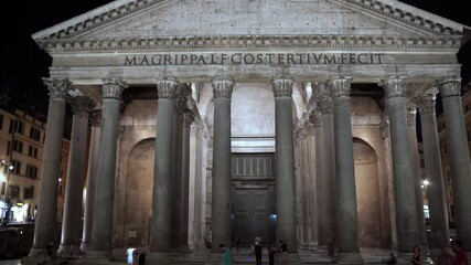 Majestic Roman Pantheon Temple illuminated at night, latin religious inscription on marble rock above the tall imperial columns. Pantheon as an italian architectural heritage - Powered by Adobe