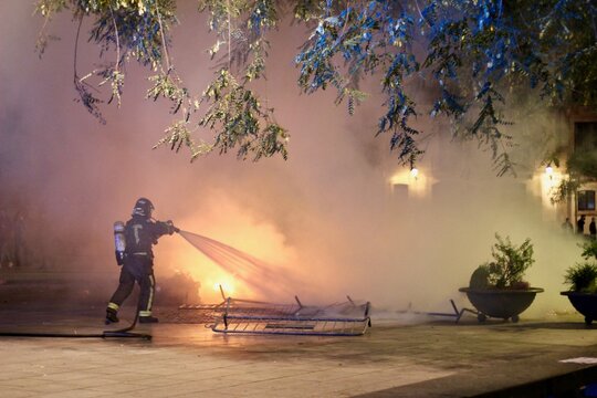 Firefighter putting out the fires of the altercations produced in the city of Barcelona
