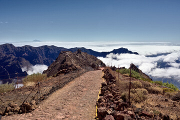 Fototapeta na wymiar Los Muchachos, the highest mountain on the Canary Island of La Palma in the late afternoon. A path to the mountain viewpoint