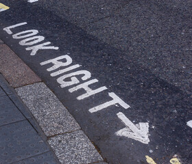 A look right warning sign painted on the road in London England.