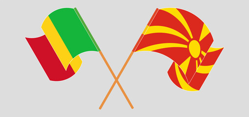 Crossed and waving flags of Mali and North Macedonia