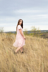 girl in a delicate dress walks in nature