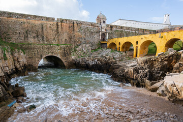 Peniche Fortress with beautiful historic bridge and sea coming from a cave, in Portugal