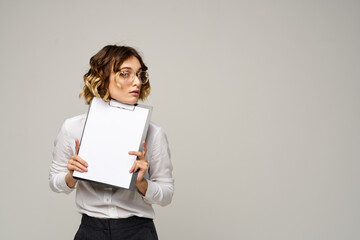 Business woman in a light shirt and a folder with documents in hands cropped view of work