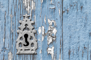 old  keyhole on vintage blue planks wooden , background