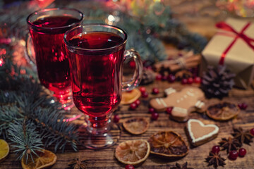 Christmas mulled red wine with and ingredients on a wooden brown table. Traditional hot drink at...