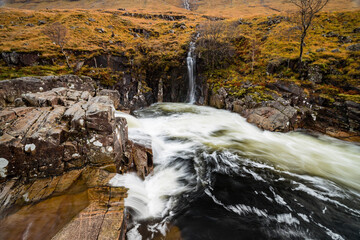 long exposure shot of the waterfalls in glen etive near loch etive and the entrance to glencoe and rannoch moor in the argyll region of the highlands of scotland during autumn