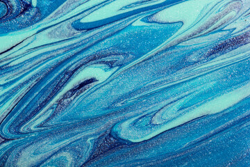Abstract glittering blue nail polish abstract background.