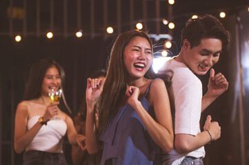 Attractive young woman drinking champagne or al fresco beer in a bar.