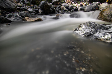 Mountain stream in the Switzerland. net blue water in Swiss Alps