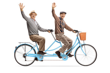 Elderly men riding a blue tandem bicycle and waving at camera - obrazy, fototapety, plakaty