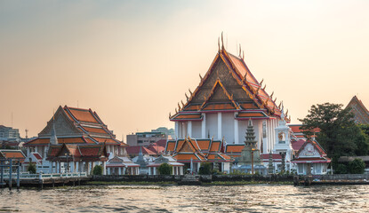 Fototapeta premium Wat Kanlayanamit in Bangkok, Thailand as Seen from the Boat Cruising the Chao Phraya River