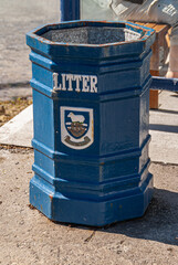 Stanley, Falkland Islands, UK - December 15, 2008: Closeup of blue public garbage, litter, can with...