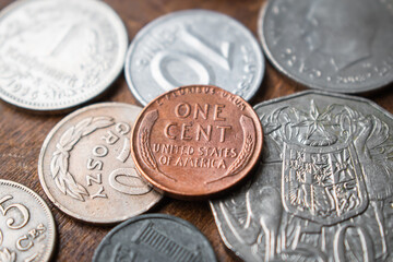 Stack of old coins with historical one cent from U.S. America on wooden background