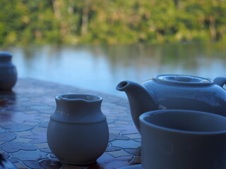 Teapot and cups on the poolside table, Ubud, Bali