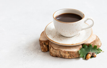 Acorn coffee on a white background. Still life with black coffee, oak leaves and acorns. Caffeine...