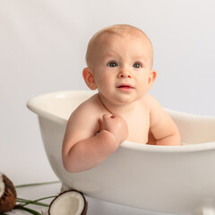 
a very funny little boy peeking out of the milk bath with a questioning expression on his face. Coconut mood