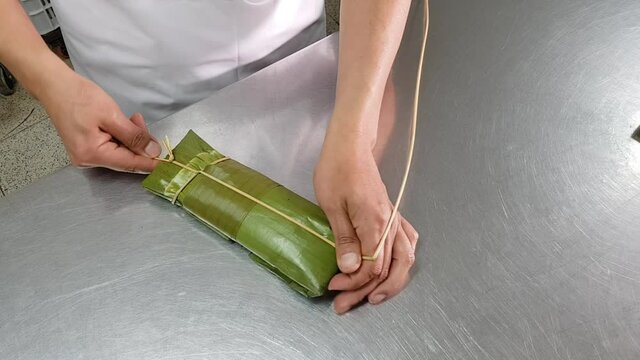 Tied with a typical Peruvian tamale made from corn, pork and olives