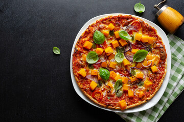Pizza with pumpkin chunks with vegetables