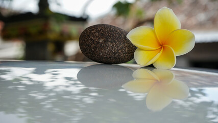 spa stones and frangipani
