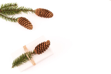 Christmas or new year composition with gift box, fir branches on white background. Flat lay, top view, copy space.