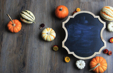 leaves and pumpkins on wooden background