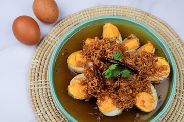 Fried egg with tamarind sauce or Sweet and Sour Eggs topped with fried onions and dried chilies. Thai food / Select focus