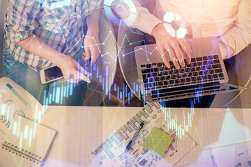 Multi exposure of man and woman working together and forex graph hologram drawing. Financial analysis concept. Computer background. Top View.