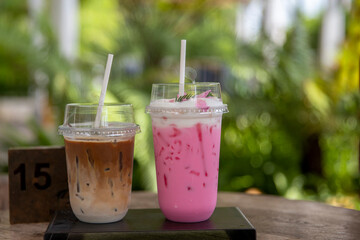 Cold milk smoothie  milkshake and ice latte coffee in take awa and has sunlight a nature background. - obrazy, fototapety, plakaty