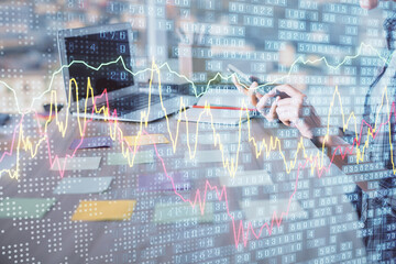 Double exposure of woman hands working on computer and forex graph hologram drawing. Financial analysis concept.