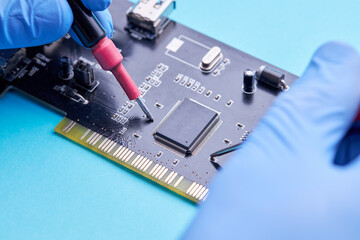 computer hardware support service concept. technician diagnosing and repairing pcb circuit board