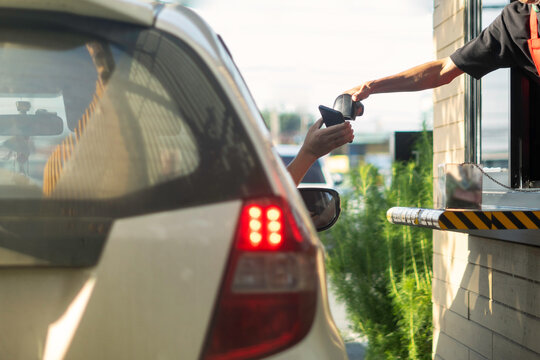 Pay for food or drinks via mobile phone using barcode reader by driving through. Prevention corolona virus or COVID-19.