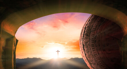 Easter concept: Tomb stone with holy cross and sunset sky background